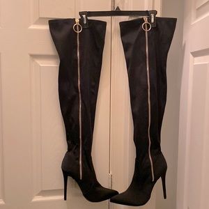Thigh high black stretch material boots.